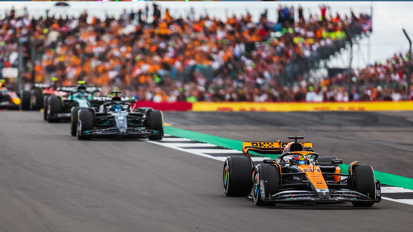 NCS4 eNewsletter's August 10, 2023 edition with Formula One Grand Prix cars on the roadway and fans in the stands behind them.